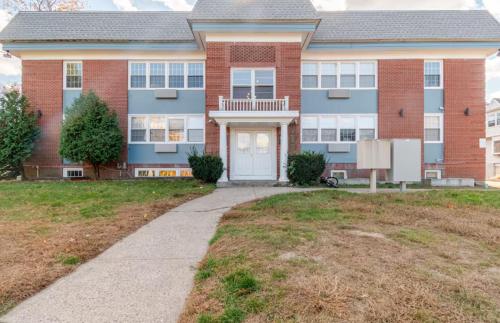 a large brick house with a white door at Westville Haven Modern 2BR Near Yale in New Haven