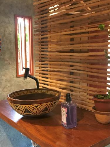 a bowl on a table with a bottle of soap at Chalé Dona Ramira in Alter do Chao