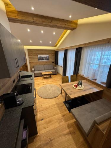 ein Wohnzimmer mit Couch und Tisch in der Unterkunft Alpenapart Schmid in Niederthai