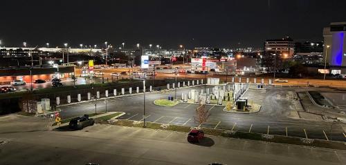 a parking lot in a city at night at Holiday Inn Express & Suites Chicago O'Hare Airport by IHG in Des Plaines