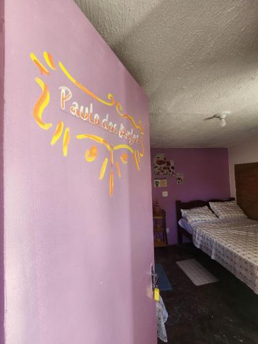 a room with two beds and a pink wall at Casa Bantu - Vila Rosa in Vera Cruz de Itaparica