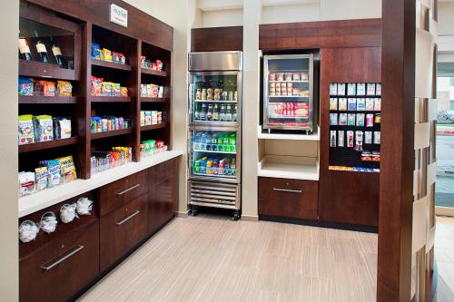 a pharmacy aisle with a refrigerator and drinks at SpringHill Suites by Marriott Carle Place Garden City in Carle Place