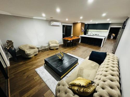 a living room with a couch and a table at Sanctuary Lakes Holiday house in Point Cook