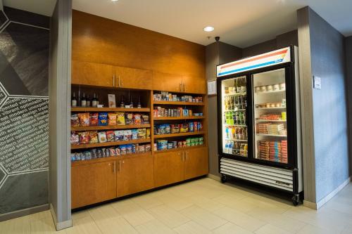 a grocery store aisle with a refrigerator and food at SpringHill Suites by Marriott Winston-Salem Hanes Mall in Winston-Salem