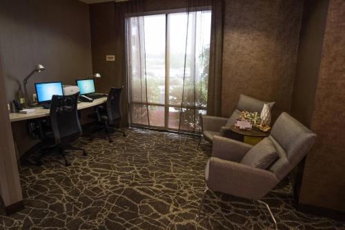 an office with two computers and a desk with chairs at SpringHill Suites by Marriott Winston-Salem Hanes Mall in Winston-Salem