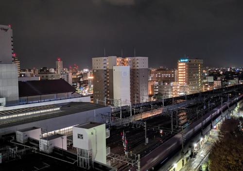 a city skyline with a train station at night at APA Hotel Kanazawa Ekimae in Kanazawa