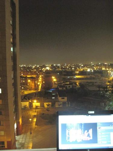 a view of a city at night from a building at Cozy Room - Margot Arimborgo in Lima