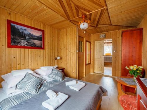 a bedroom with a large bed with pillows on it at Anna Wilczek - Pokoje z Góralską Duszą - Bukowina Tatrzańska in Bukowina Tatrzańska