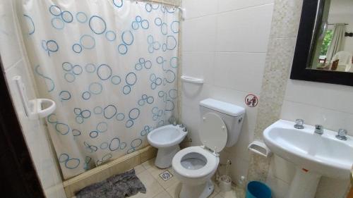 a bathroom with a toilet and a sink at Cabañas OliBer in Potrero de los Funes