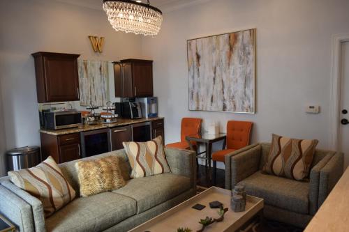 a living room with two couches and a kitchen at The William Boerne in Boerne