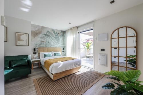 a bedroom with a bed and a green couch at ATyCO Madrid in Madrid
