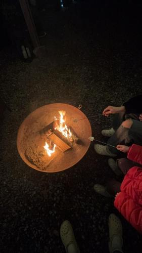 a group of people sitting around a fire pit at Loch Ness Pods in Fort Augustus
