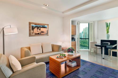 a living room with a couch and a table at The Ritz-Carlton, Bahrain in Manama
