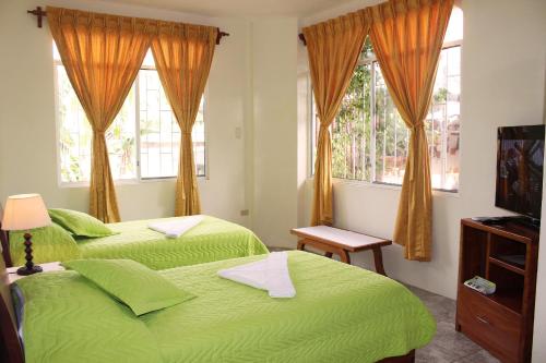 Postel nebo postele na pokoji v ubytování Hotel Del Sol Galapagos