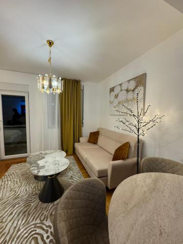 a living room with a couch and a table at Mocha Belgrade Apartment in Belgrade
