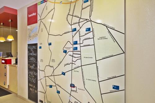 a map on the wall of a office building at TownePlace Suites Republic Airport Long Island Farmingdale in Farmingdale