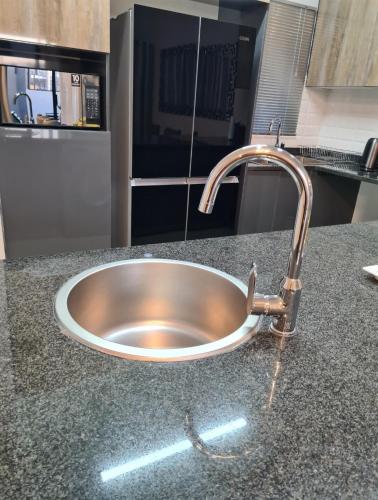 a stainless steel sink in a kitchen counter at Lerewa in Gaborone