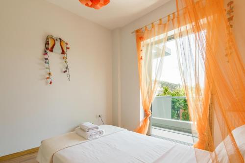a bedroom with a bed and a window at Luxury modern villa with swimming pool, Athens Riviera in Lagonissi