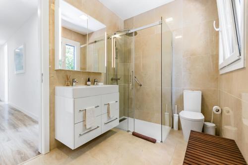 a bathroom with a shower and a sink and a toilet at Xitaka Country House - Modern Large Great Views in Torres Novas