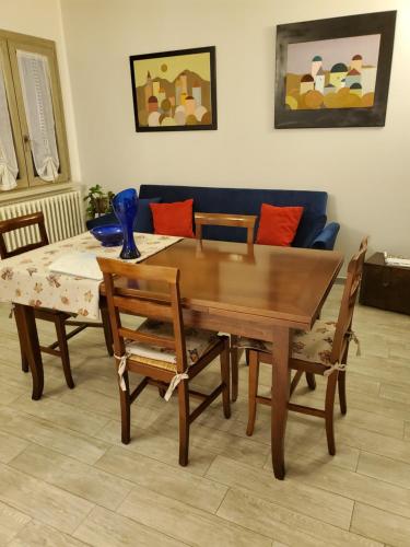 a dining room table with two chairs and a couch at Casacobelli in Monzambano