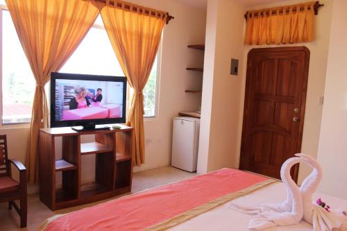 TV a/nebo společenská místnost v ubytování Hotel Del Sol Galapagos