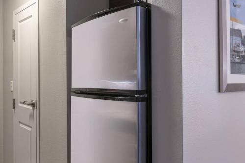 a stainless steel refrigerator in a kitchen next to a door at TownePlace Suites by Marriott Providence North Kingstown in North Kingstown