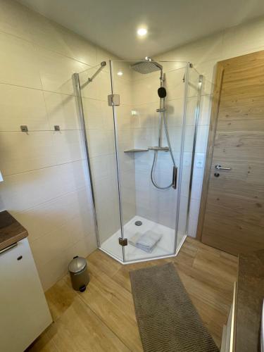 a shower with a glass door in a bathroom at Ferienwohnung Radler in Stumm