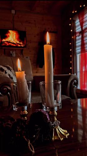 two candles on a table in a living room at Villa in Rugovë, Kosovo in Lekaj