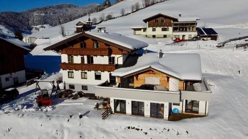 a building with snow on top of it at Bio Bauernhof Oberbenk in Wagrain