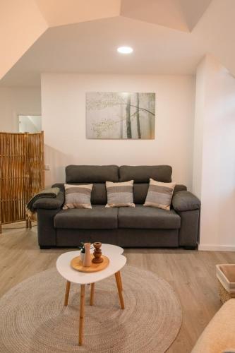 a living room with a couch and a table at Casa das Faias - Serra da Estrela in Manteigas