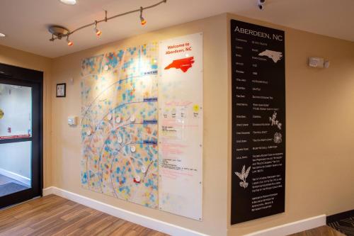 a wall with a map and a menu at TownePlace Suites by Marriott Southern Pines Aberdeen in Aberdeen