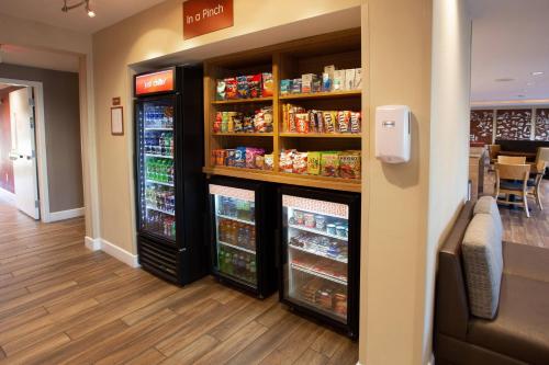 a store aisle with two refrigerators and food at TownePlace Suites by Marriott Southern Pines Aberdeen in Aberdeen