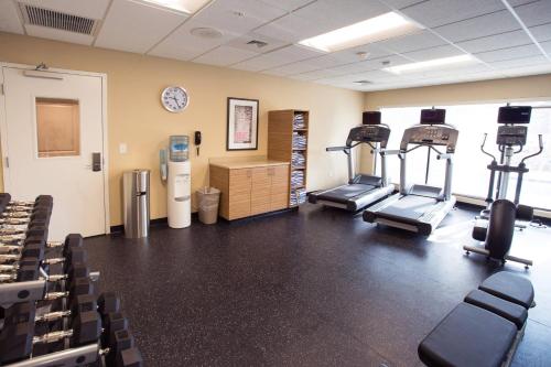 a gym with cardio equipment in a room with chairs at TownePlace Suites by Marriott Southern Pines Aberdeen in Aberdeen