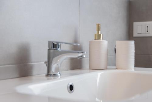 a bathroom sink with a faucet and two rolls of toilet paper at Il riccio di Ricciano in Casale Corte Cerro