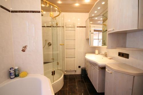 a bathroom with a shower and a toilet and a sink at Villa Alpenoase in Schönau am Königssee