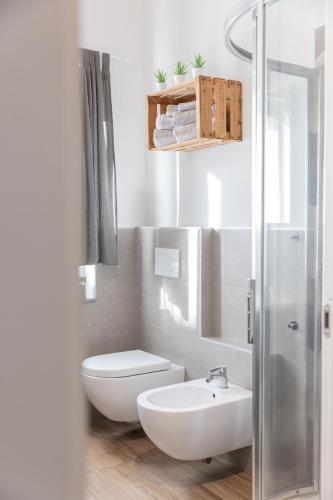 a white bathroom with a toilet and a sink at Il riccio di Ricciano in Casale Corte Cerro