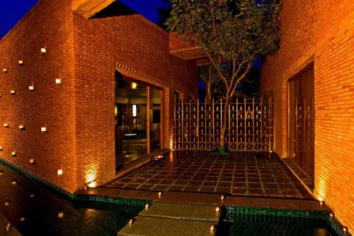 a brick building with a pool in front of it at The Westin Sohna Resort & Spa in Gurgaon