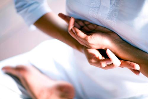 a close up of a persons hands on a bed at The Westin Sohna Resort & Spa in Gurgaon