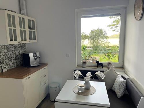 a kitchen with a table and a large window at sanierte ruhige Wohnung in der Natur mit Küche in Wettringen