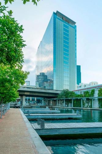 a tall building with a reflection in the water at The Westin Cape Town in Cape Town