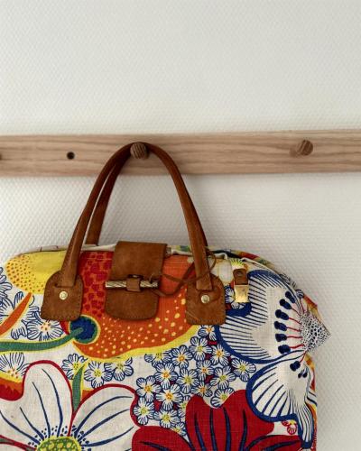 a purse is hanging on a wall at Atelier Blå houses in Rösselvik
