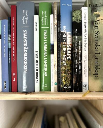 a row of books on a book shelf at Atelier Blå houses in Rösselvik