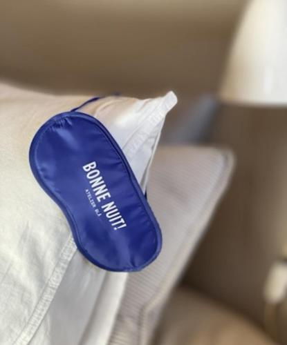 a blue item on top of a white pillow at Atelier Blå houses in Rösselvik
