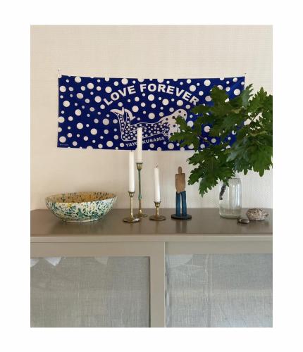a table with two candles and a love forever banner at Atelier Blå houses in Rösselvik