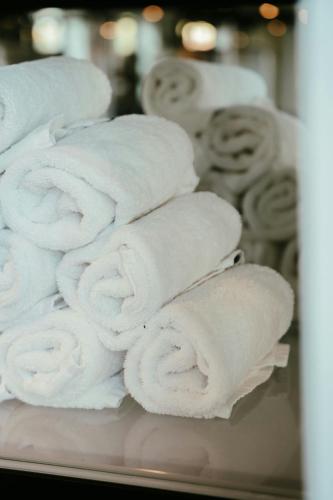 a stack of white towels on a shelf at Residence Inn by Marriott Ghent in Ghent
