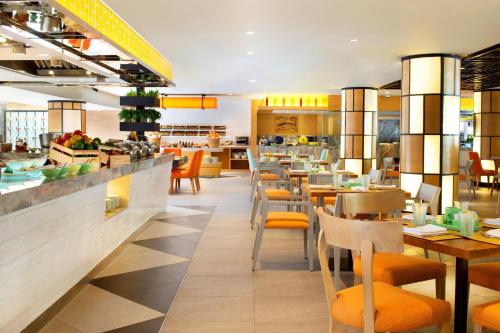 a restaurant with tables and chairs and a bar at The Westin Resort Nusa Dua, Bali in Nusa Dua