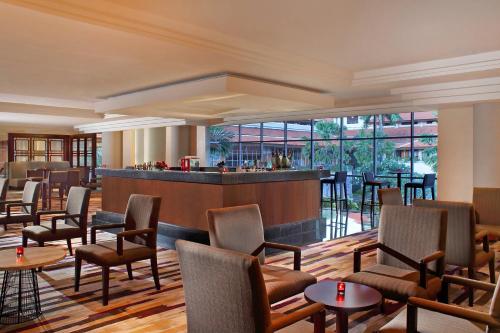 a lobby with a bar and chairs and tables at The Westin Resort Nusa Dua, Bali in Nusa Dua