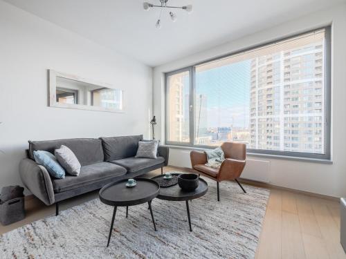 a living room with a couch and chairs and a large window at Apartmán s výhľadom v centre, Downtown, Sky Park in Nivy