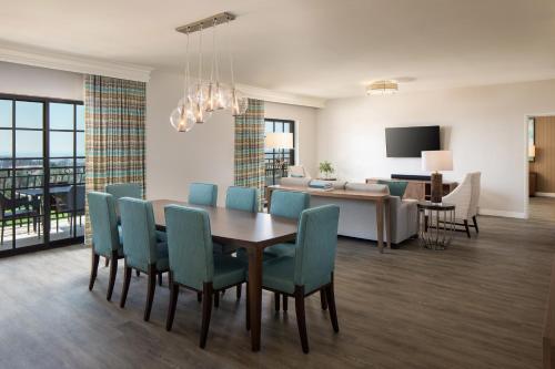 a dining room and living room with a table and chairs at The Westin Carlsbad Resort & Spa in Carlsbad