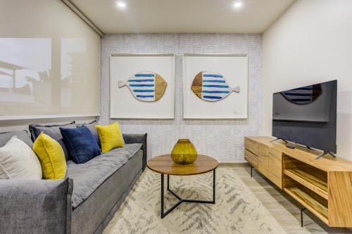a living room with a couch and a table at Porto 15 Condominios in Puerto Vallarta